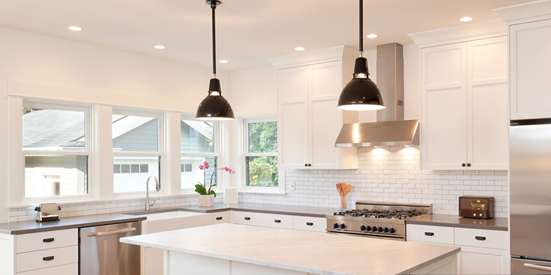 Modern kitchen with pendant lights, bright and clean design