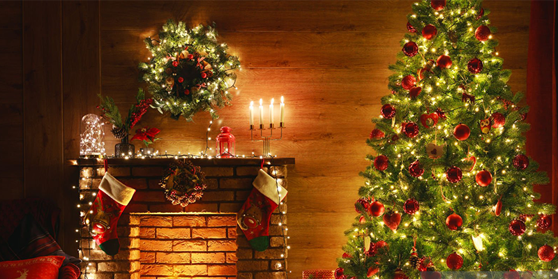 Christmas decorations with lit tree and fireplace, festive atmosphere