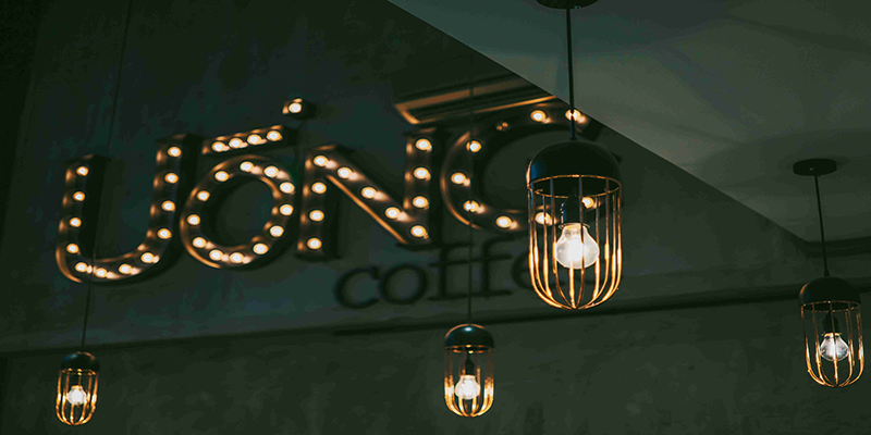 cage pendant lights in a modern café, warm and inviting atmosphere