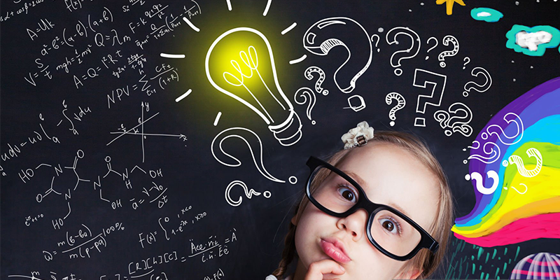 Child thinking with glowing light bulb on chalkboard background, creative concept