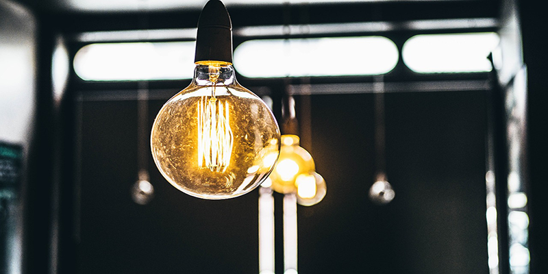 Close-up of a vintage-style filament bulb glowing warmly