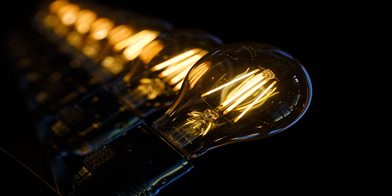 Row of LED filament bulbs glowing in the dark, perfect lighting design