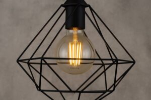 Geometric wire cage pendant light in diamond or cube shape featuring a clear Omita G95 LED Edison bulb glowing warmly inside