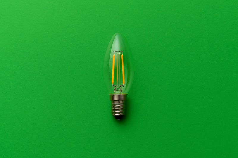 LED bulb on green background symbolizing sustainability