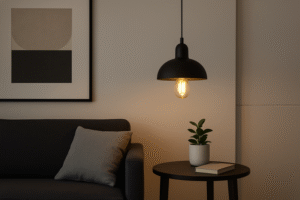 A sleek, modern living room where a minimalist pendant fixture with a visible Omita LED Edison bulb hangs over a side table, adding a touch of warmth